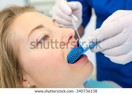 Dentist using a mouth guard on a a woman