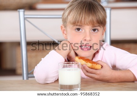 Little girl with jam and milk