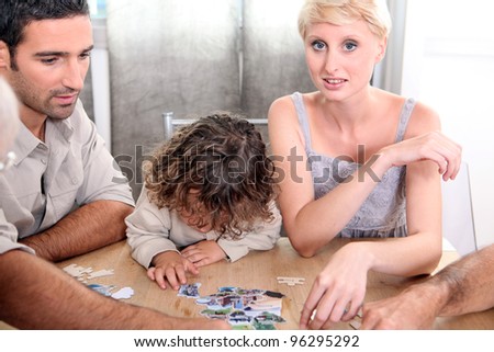 A family making a jigsaw puzzle.