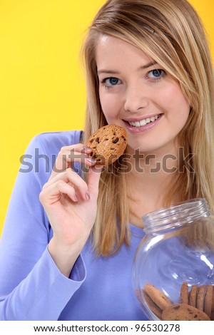 http://image.shutterstock.com/display_pic_with_logo/286756/96530278/stock-photo-woman-eating-a-cookie-96530278.jpg