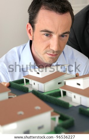 Architect staring at a model