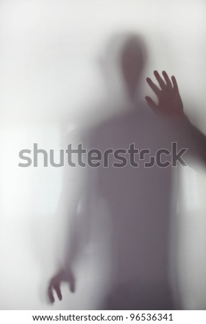 Person stood behind frosted glass