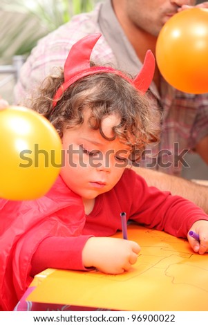 Young boy in a Halloween devil's costume
