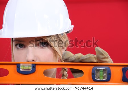 Female manual worker with spirit level