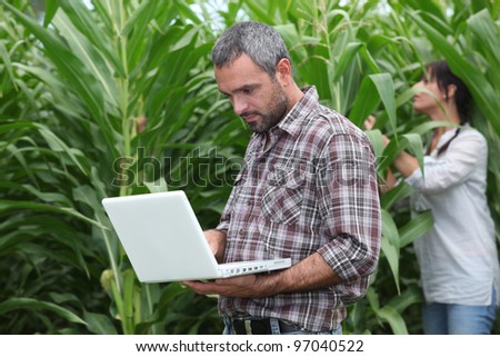 man and woman in a field - stock photo