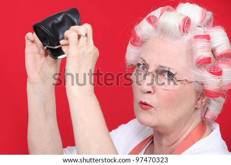 grandma with hair curlers and empty purse