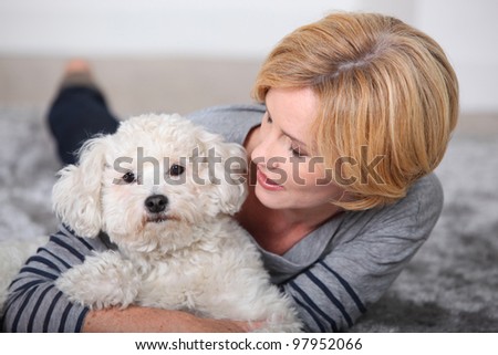 beautiful woman holding a little dog