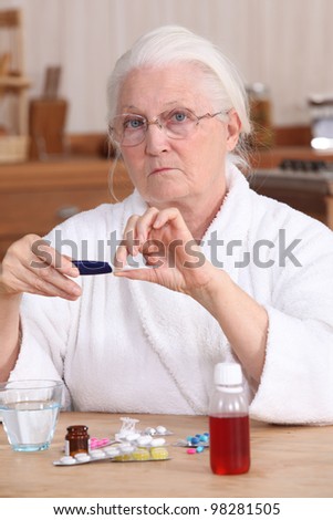 Elderly woman taking her medication