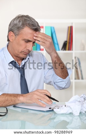 Businessman struggling at his desk