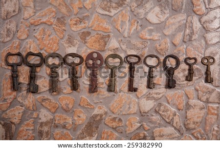 collection of old keys on stone floor