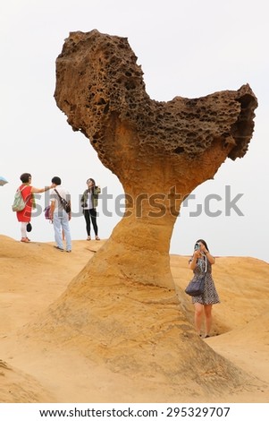 YEHLIU, TAIWAN - APRIL 17, 2015: Heart-shape rock at Yehliu Geopark Park, Taiwan on April 17, 2015. This famous cape, on northern of Taipei, attracted tourist coming to see a number of rock formations