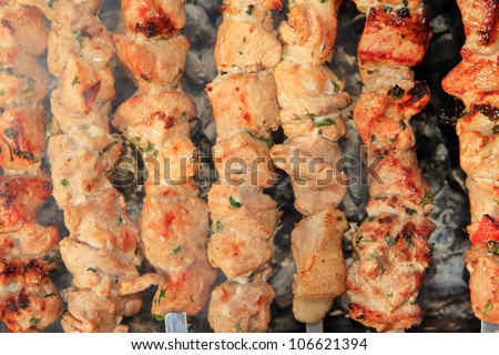 Juicy slices of meat with sauce prepare on fire