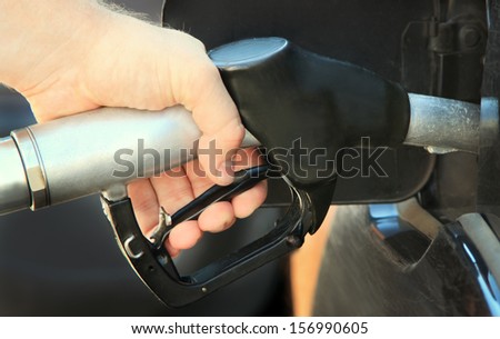 Refilling the car with unleaded petrol