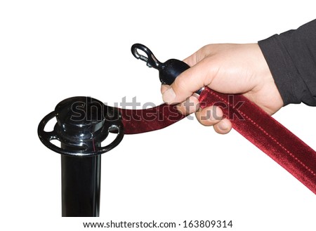 Human hand open red velvet rope isolated over white
