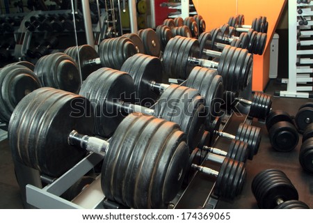 Dumb bells lined up in a fitness studio. Shot focus