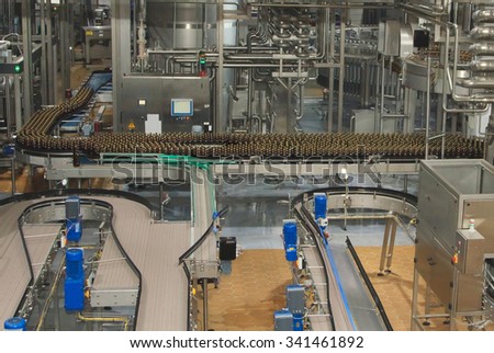 Moscow, Russian Federation - March 07, 2015: Plastic water bottles on conveyor or water bottling machine