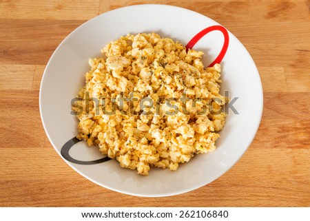 Scrambled eggs with cheese and basil.