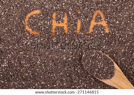 Chia seeds on a wooden board and inscription \