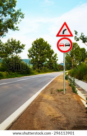 No overtake and three-cornered right turn sign on a highway in Europe.