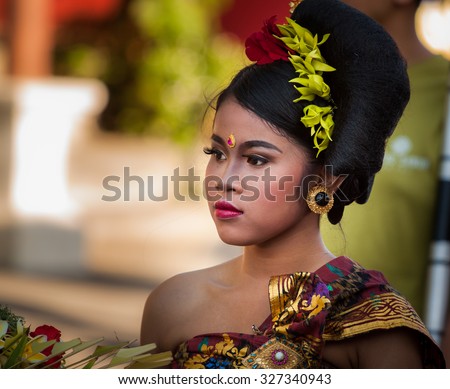 BALI, INDONESIA - AUGUST 30, 2015: beautiful young Balinese woman in traditional attire at Sanur Village Festival\'s street parade on August 30th, 2015 in Bali, Indonesia.