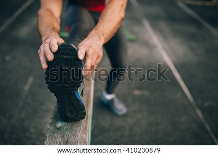 man stretches the body before running