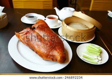 Chinese food/Beijing duck on white plate and  basketwork used for packaging steamed bun