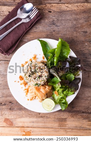 Isolated healthy fried rice with fork and spoon wooden background/ Vintage food