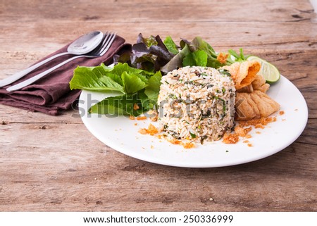 Isolated healthy fried rice with fork and spoon wooden background/ Vintage food