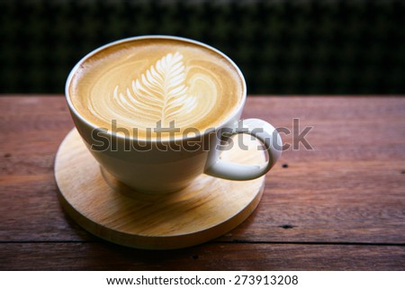 coffee latte / Cup of cappuccino. /hot milk art coffee on wooden table\
Photo in old image style.