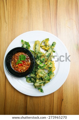 Thai style appetizer of fried tempura asparagus with dipping sauce.
