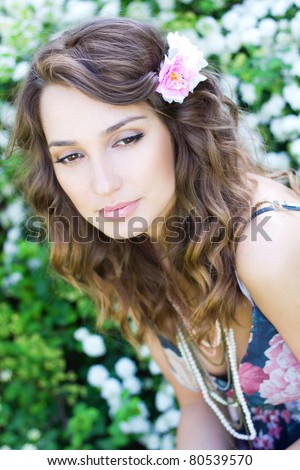 Thoughtful lady with flower in her hair