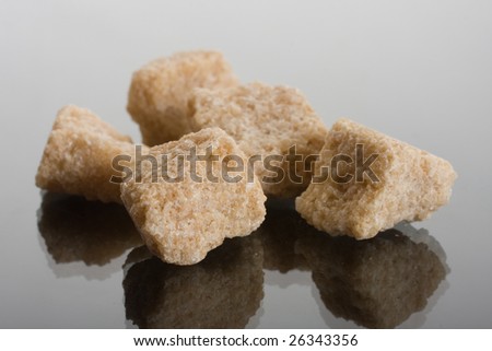 brown sugar pieces on glass background