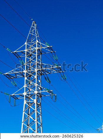 An electricity pylon sends power to all of the people