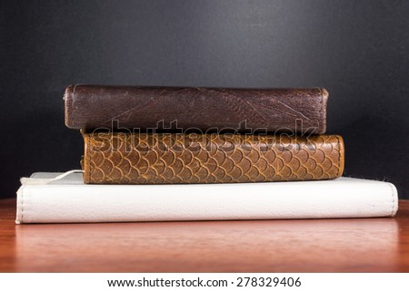 Fake imitation leather spines of books and an e-reader