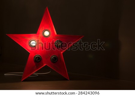 Single red soviet star lamp display with broken bulbs