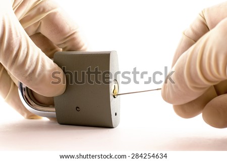 Thief breaking into a locked grey metal padlock