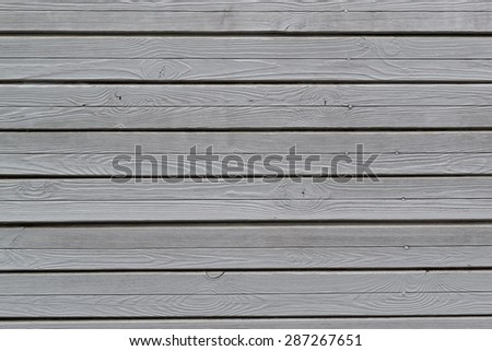 Grey painted wooden wall texture with knots and nail heads