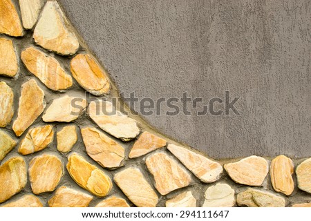 Stone tiled wall with grey cement copy space area