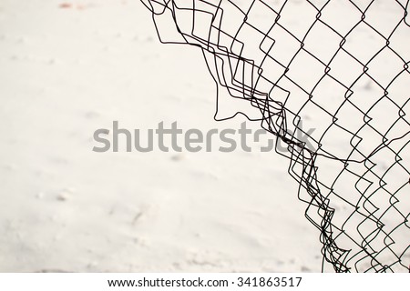 Broken chain link fence with a snow white background