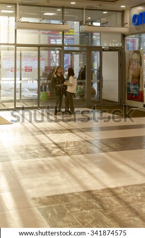 UFA - RUSSIA 15TH NOVEMBER 2015 - Single young woman Russian shopper talks with a canvasser at the entrance of a large shopping centre in Ufa, Russia in 2015
