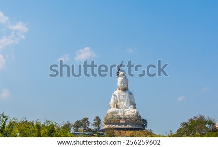 Guanyin The majority of the power of faith. Statue of Guanyin Chinese Goddess with blue sky background.