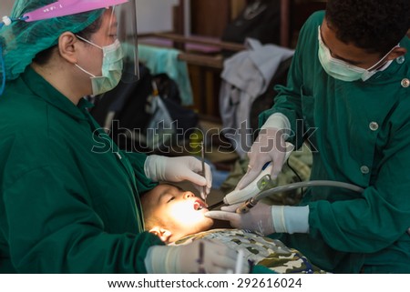 CHIANG RAI, THAILAND -MARCH 29 2015: Unidentified dentist volunteer from public hospital are in medical services at Ban Huai Ya Sai school on March 29,2015 in Chiang rai,Thailand.