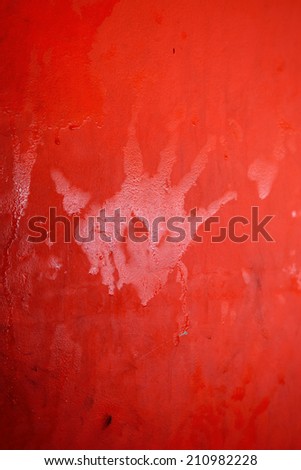 hand print on red wall