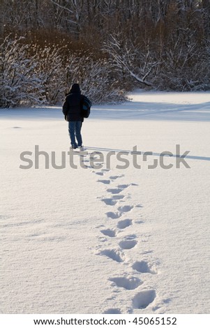 The man going through a snow field and leaving scars in snow