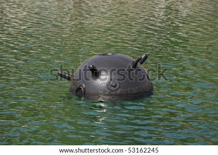 Underwater mine on a water surface, photographed at a short distance