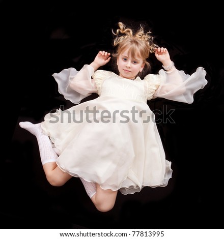 Girl in elegant white dress laying on floor