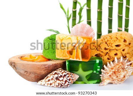 Handmade soaps and beauty care tools on white background