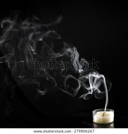 Extinguished candle with smoke