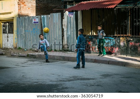 Istanbul, Turkey - January 12, 2016: Three boys are playing ball in the street of Istanbul, Turkey