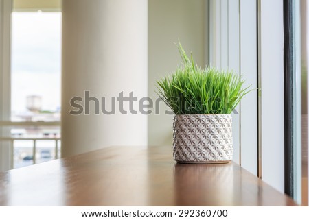 Grass in vase on wood table in the cozy room